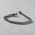 Franco chain bracelet in silver on a concrete surface